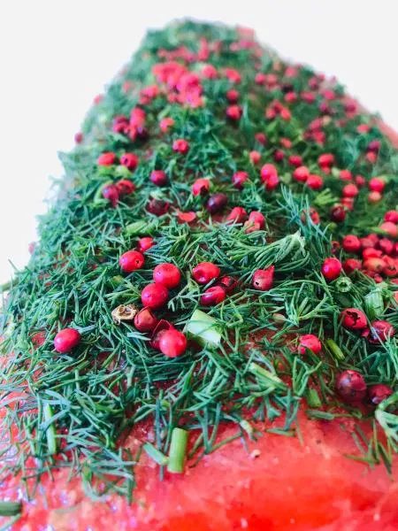 Stained (graved) salmon trout with fresh dill and pink berries